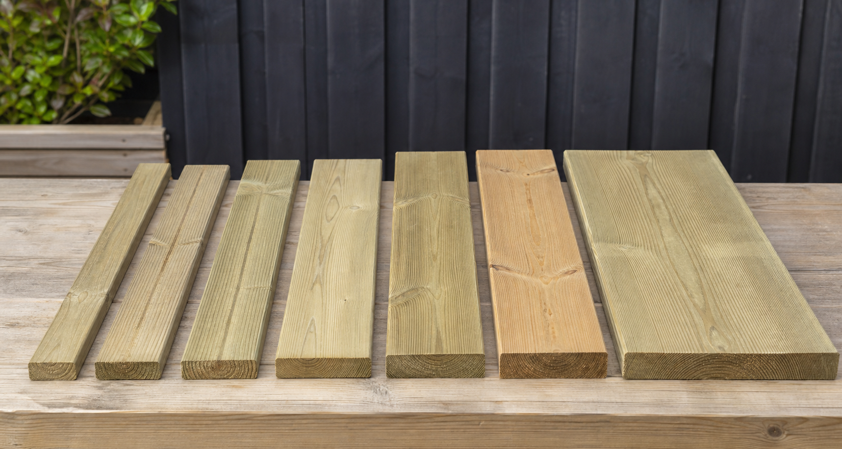 Deck boards in different widths compared with a tape measure and planning sheet